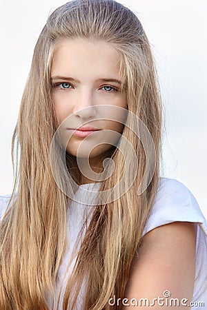 Beautiful sorrowful girl with long hair looks Stock Photo