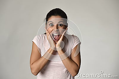 Beautiful Spanish surprised woman amazed in shock and surprise happy and excited Stock Photo