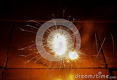 Beautiful sparklers on the block brick floor. Stock Photo