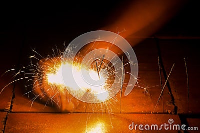 Beautiful sparklers on the block brick floor. Stock Photo