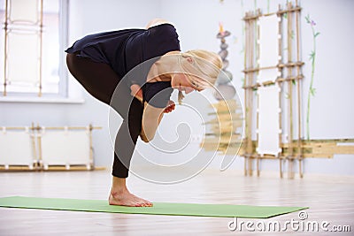Beautiful sporty fit yogi woman practices yoga twist asana in the fitness room Stock Photo
