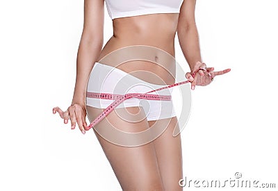 Beautiful sporty woman with measure tape around body Stock Photo