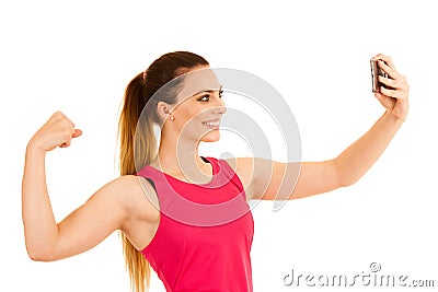 Beautiful sporty woman standing doing selfie with arm in fist over white background Stock Photo