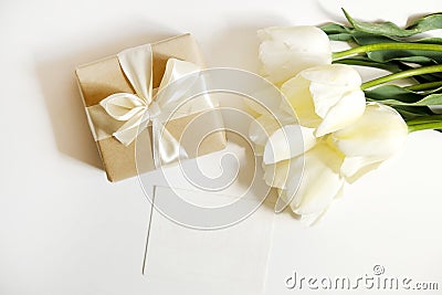 Beautiful spring holidays flowers arrangment. Bunch of white tulips in festive composition, copy space for text, white background. Stock Photo