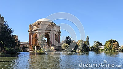 A beautiful spring landscape at Palace of Fine Arts with a lake, lush green trees and plants and beautiful buildings with blue sky Stock Photo