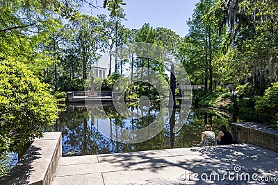 a beautiful spring landscape in the Sculpture Garden at New Orleans City Park with a lake, lush green trees, grass and plants Editorial Stock Photo