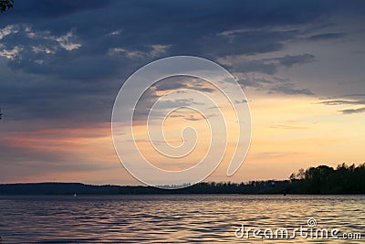 Spring sunset on the river with a beatiful sky in pastel colors and silhoettes of trees. Stock Photo