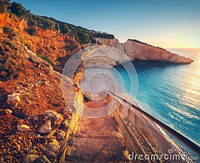 Beautiful stairs on sandy beach at sunset. Porto Katsiki, Greece Stock Photo