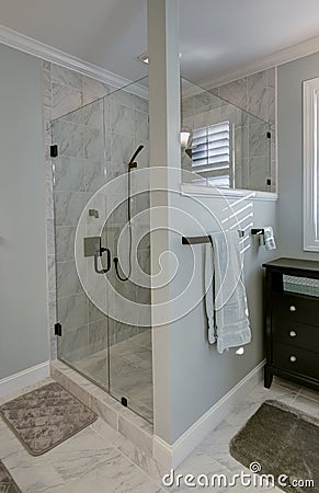 Beautiful stand alone glass shower with luxury marble tile and glass door Stock Photo