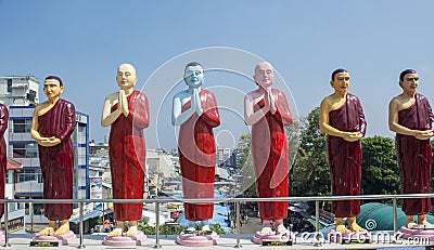 Beautiful statues of buddhist saints on the roof of the temple in Colombo Stock Photo