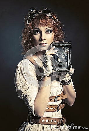 Beautiful steampunk girl with old camera Stock Photo