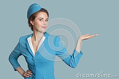 Beautiful stewardess holding blank on her hand. Stock Photo