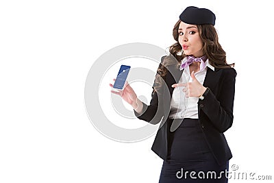 beautiful stewardess pointing on smartphone with facebook website Editorial Stock Photo