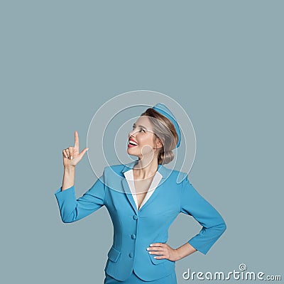 Beautiful stewardess points a finger on copyspace. Stock Photo