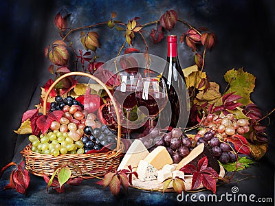 Beautiful still life with wine glasses, grapes, pomegranate on t Stock Photo