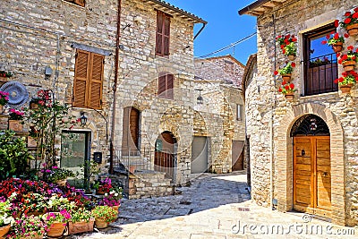 Stone buildings of the flower filled old town of Assisi, Italy Stock Photo