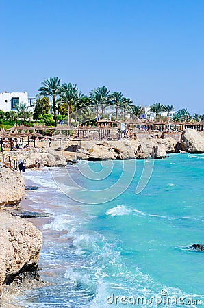 Beautiful palm beach, splash sea waves and blue sky. Ras Um Sid Stock Photo