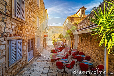 Beautiful street with flowers in the Hvar town, Hvar island, Dalmatia, Croatia. Old Mediterranean street, Hvar town. Old Adriatic Stock Photo