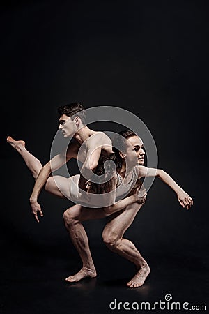 Beautiful strong gymnasts performing together in the studio Stock Photo