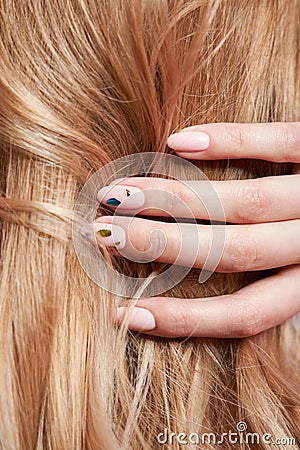 Beautiful strong hair of a woman, strengthening and restoring the hair roots. Beautiful manicure on the hands of a girl Stock Photo