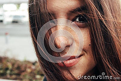 beautiful stylish brunette girl smiling with freckles on background of modern airport Stock Photo