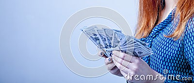 Beautiful success business woman holding 100 dollar currency ban Stock Photo