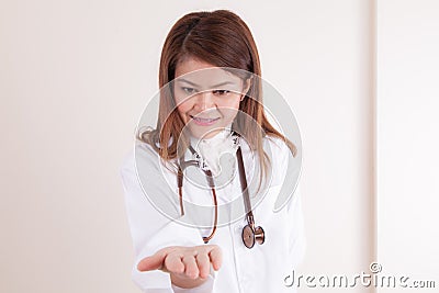 Beautiful successful doctor holding something on her hands Stock Photo