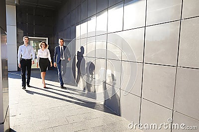 Beautiful successful people, two guys and girl, young businessme Stock Photo