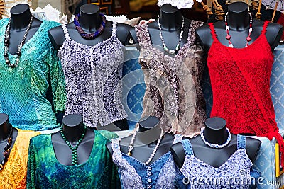 Beautiful summer blouses in a street shop in a tourist town. Stock Photo