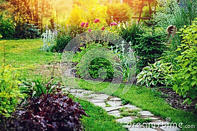 beautiful summer cottage garden view with stone pathway Stock Photo