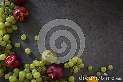 Beautiful summer fruits border on dark background Stock Photo