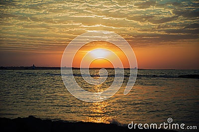 Beautiful summer golden sunset above the black sea.with calm waves and reflection of sun on the beach.Azerbaijan nature Stock Photo