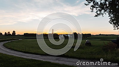 Beautiful summer landscape countryside at sunset. Path to the village. Great holiday home in the countryside. Evening. Stock Photo