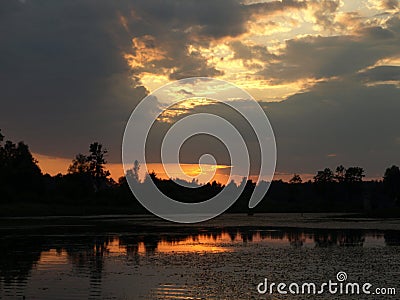 Beautiful sun set on calm lake, red sun, Stock Photo