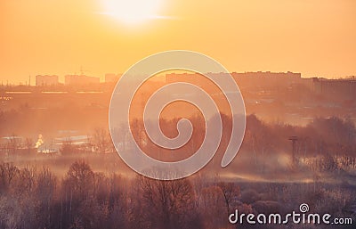 Beautiful sunny landscape with forest and city buildings on the horizon in the frosty winter morning Stock Photo