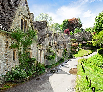 A beautiful sunny morning in Bibury, Gloucestershir, England, UK. Old street with traditional cottages Stock Photo