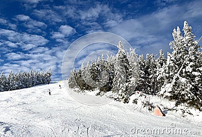 Beautiful sunny snow day with blue sky and clouds at the Stowe Mountain Ski resort Vermont Stock Photo