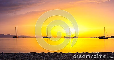 Beautiful sunrise on the Aegean Sea. Boats in ancient bay of Datca Peninsula. Stock Photo