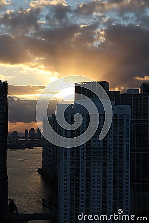 Beautiful sunrise in downtown miami. the sun breaks through the clouds and skyscrapers. view from the 38th floor Stock Photo