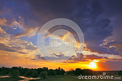 Beautiful sunrise and dramatic clouds on the sky. Stock Photo