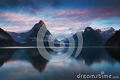 Beautiful sunrise in Milford Sound, New Zealand. Mitre Peak is the iconic landmark of Milford Sound in Fiordland National Park. Stock Photo