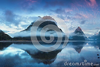 Beautiful sunrise in Milford Sound, New Zealand. Mitre Peak is the iconic landmark of Milford Sound in Fiordland National Park. Stock Photo