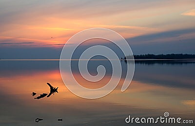 Beautiful sunrise mirrored in water smooth surface. Dnieper river, Ukraine Stock Photo