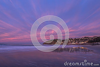 Beautiful sunrise of old jetty piles at St. Clair Beach in Dunedin, New Zealand Stock Photo