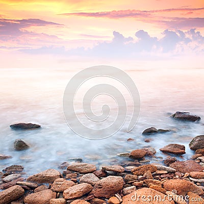 Beautiful sunrise over the rocky sea coast Stock Photo