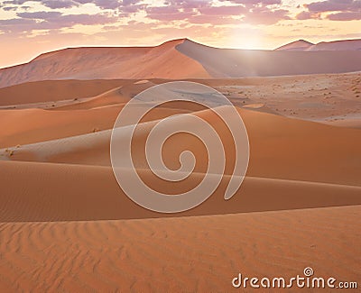A beautiful sunrise over sand dunes in Namibia. Stock Photo