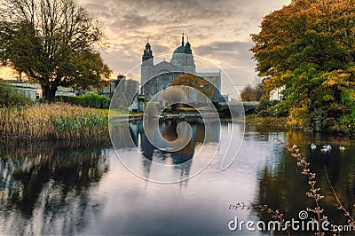 Beautiful sunrise scenery of Galway cathedral reflected in the Corrib River at Galway City Editorial Stock Photo