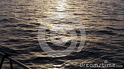 Beautiful sunset above the sea and the deck of the yacht edge. Stock. Stunning seascape, ripple in the see and the sun Stock Photo