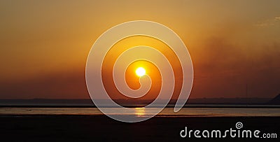 Sea ebb golden sunset over the sea and citythe sun. Sea of Azov .nice . low tide .beautiful sunset Stock Photo