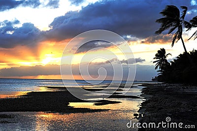 Beautiful sunset captured over a tranquil shoreline on a radiant day Stock Photo